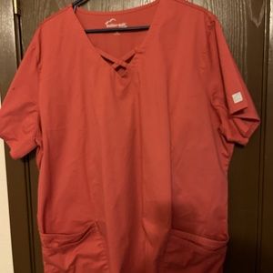 Buttersoft scrub top. Coral colored, criss cross neck line.